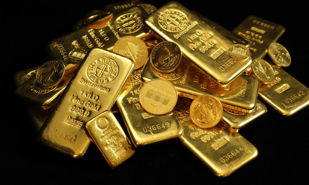 Close up of gold bullion with dark black background scaled