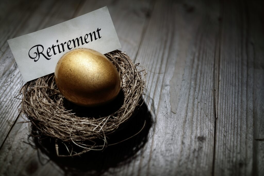 gold egg in nest with words "retirement" on paper
